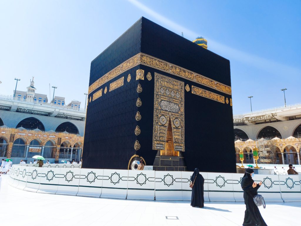 Pilgrims in Kaaba in Macca al Haram - umrah Socially Distanced coronavirus restrictions face mask