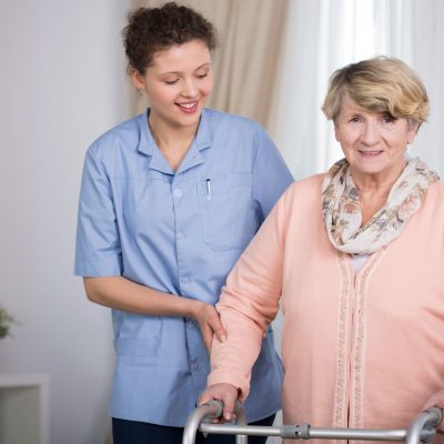 Senior woman and supporting nurse at home