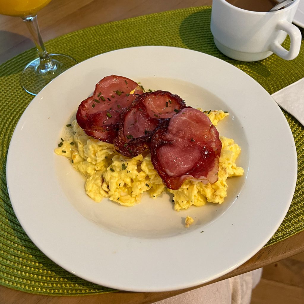 Gluten-free breakfast at Les Pénates, Mazamet (Carcassonne). Scrambled eggs with bacon