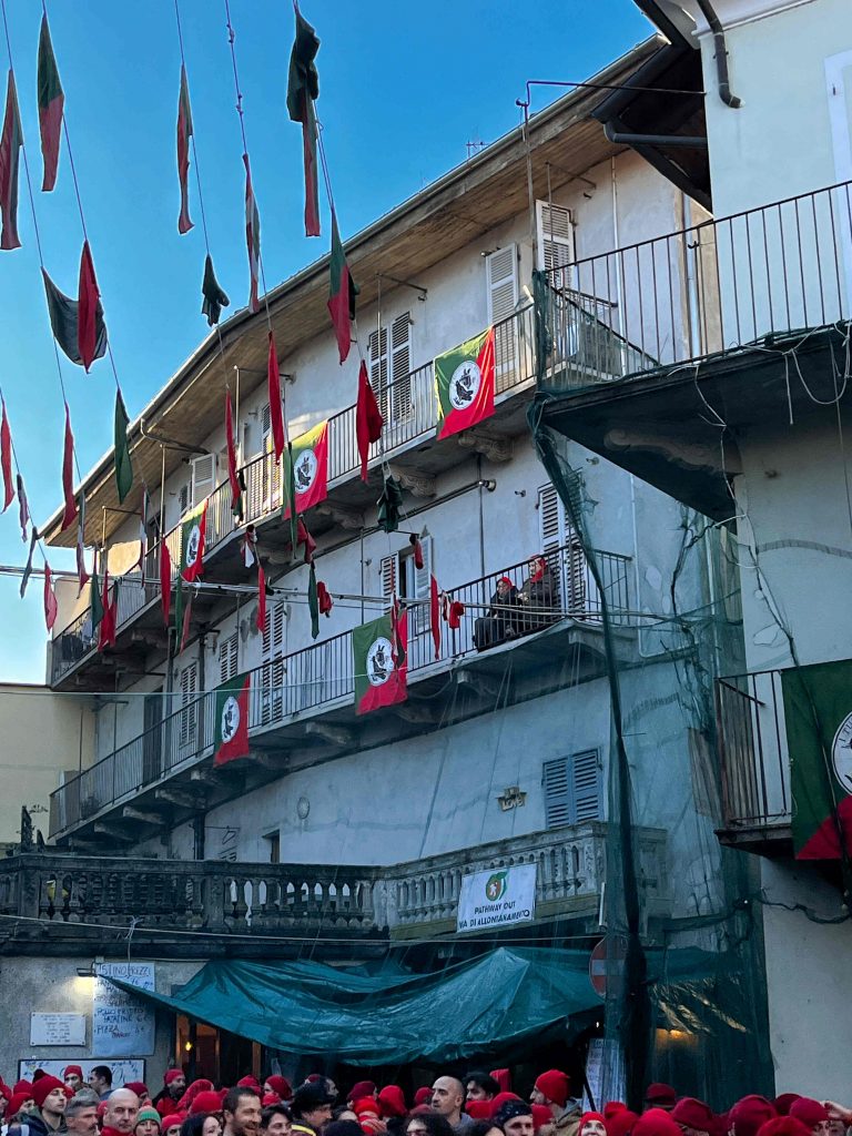 Old ladies watching the battle from balcony, Carnival di Ivrea, Italy