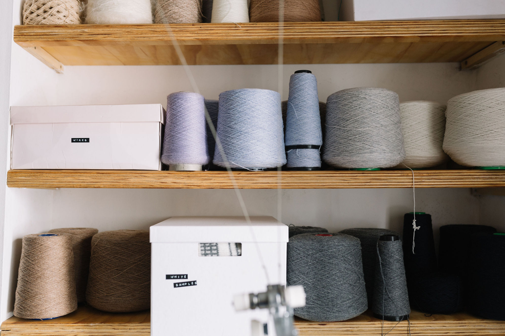 cones of wools on a shelf