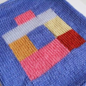 a knitted swatch using intarsia in bright colours