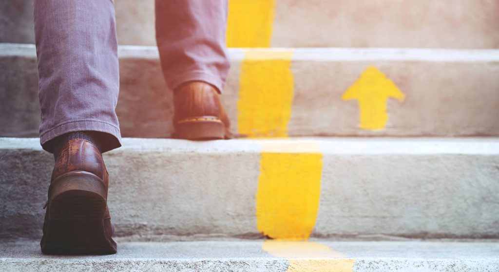 close up image of man climbing stairs