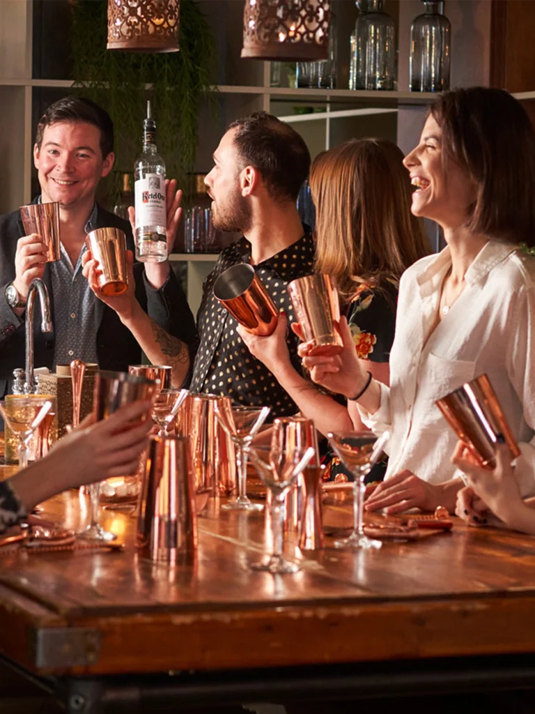 Group of people having fun at a party and mixing drinks