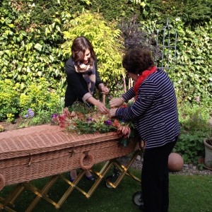 A Natural Undertaking Wicker Coffin decorating natural family flowers