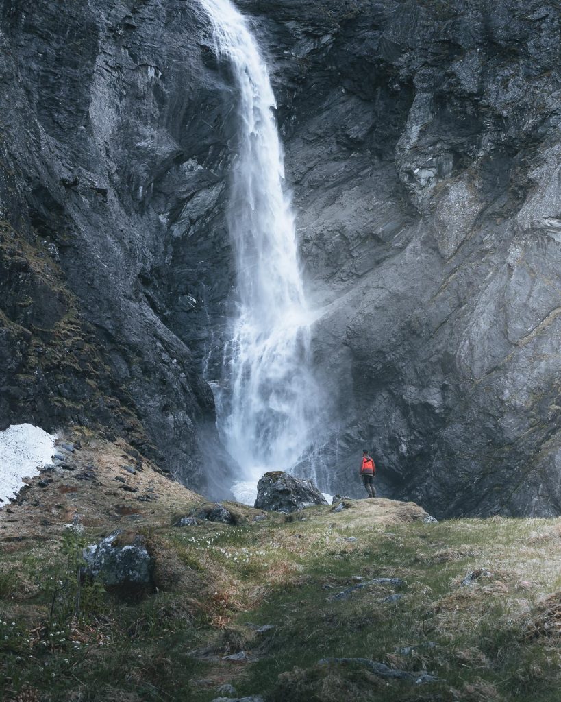 guy in front of big waterfall