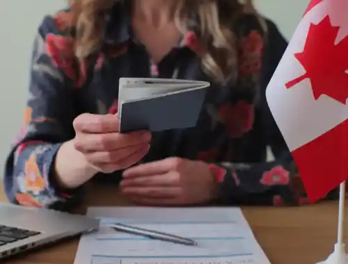 canadian-woman-consular-officer-giving-passport-male-immigrant-work-visa-citizenship-visa-application-online-form-immigration-concept-visa-approval-2