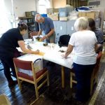 coproduction volunteers working with collections staff auditing items in the collection