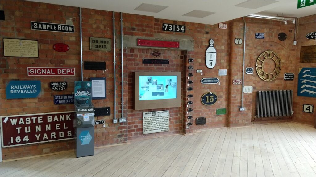 view of touchscreen on wall surround by railway memorabila