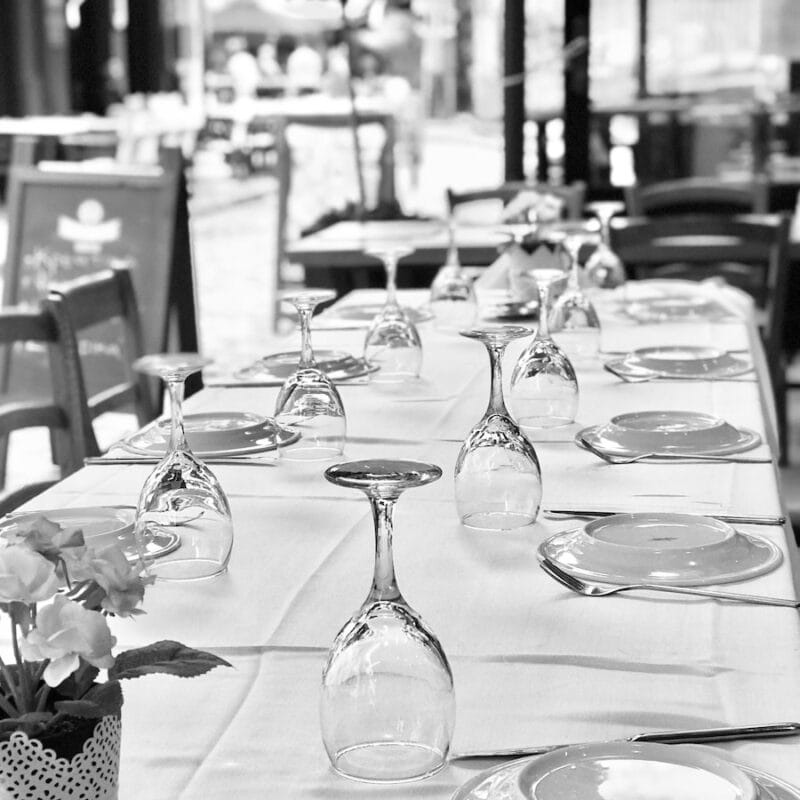 a long table with a vase of flowers on it