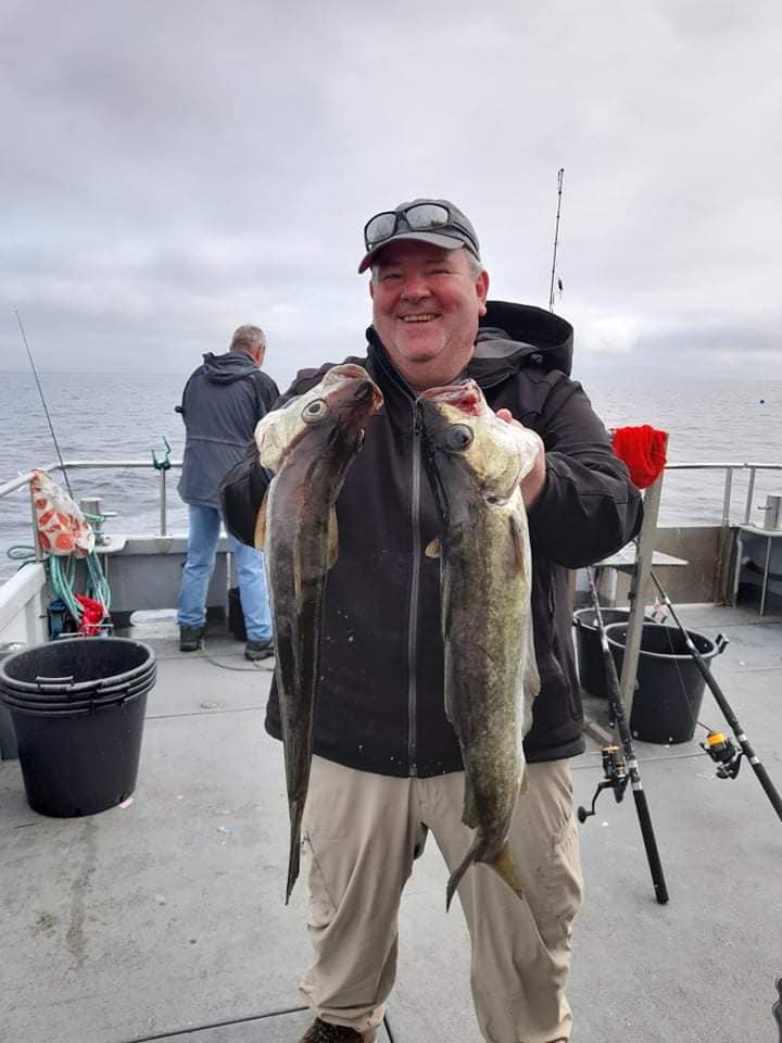 Fisherman with two fish