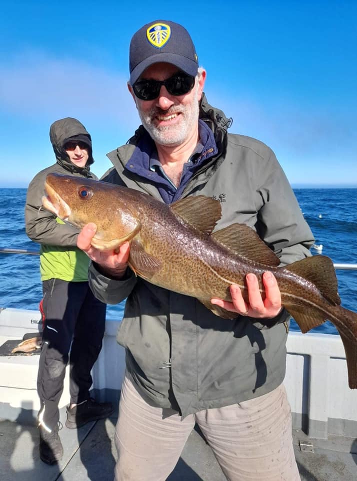 Fisherman holding a cod