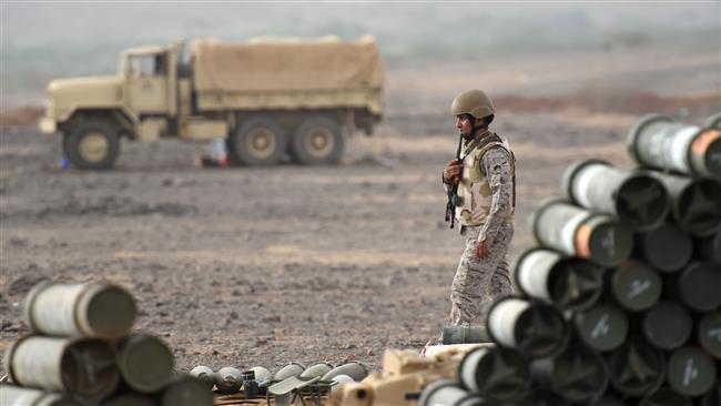 The file photo shows a Saudi soldier walking near ammunition at a position close to the Saudi-Yemeni border, in Saudi Arabia's southwestern province of Jizan. (AFP photo)