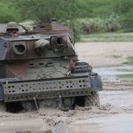 A KDF vehicle manoeuvres in stagnant water in Afmadow, Somalia, on November 22, 2015. According to Dr Ochieng’ Kamudhayi, a security and conflict expert, the military has no choice but to leave Somalia. PHOTO | JEFF ANGOTE | NATION MEDIA GROUP