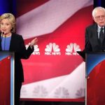 Hillary Clinton (L) and Bernie Sanders (R) speak simultaneously at a debate in Charleston, South Carolina on January 17, 2016. (Photo by Reuters)