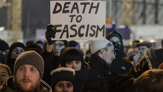 A protester holds a sheet reading 'Death to Fascism' during a demonstration near the place of the terror attack on a Christmas market in Berlin on December 21, 2016.