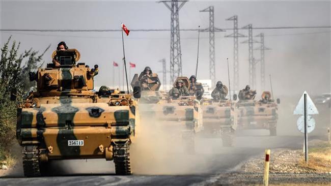 This picture taken from near the Turkish town of Karkamis on August 25, 2016 shows Turkish army tanks driving to the Syrian border town of Jarablus.