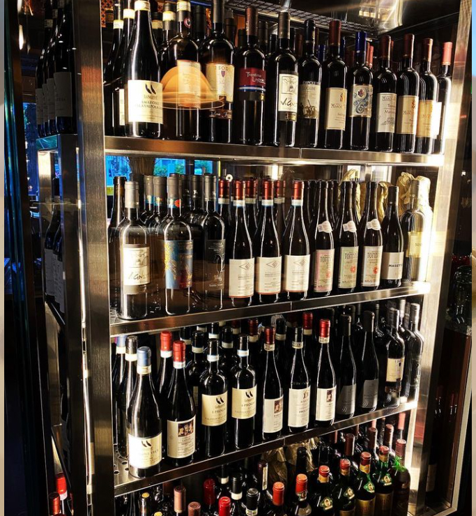 The glass wine climate cabinet, filled with the finest red wines, selected with love