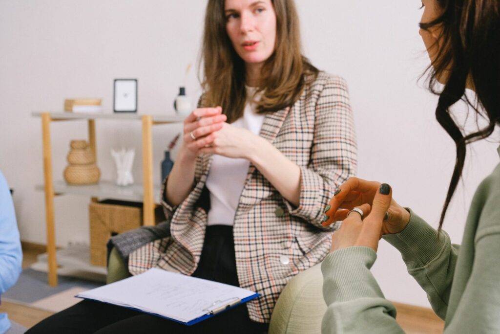 Two women doing art therapy and storytelling session in a room.
