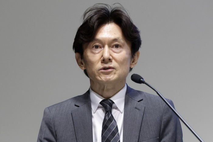 Takeshi Okazaki speaks at a press conference