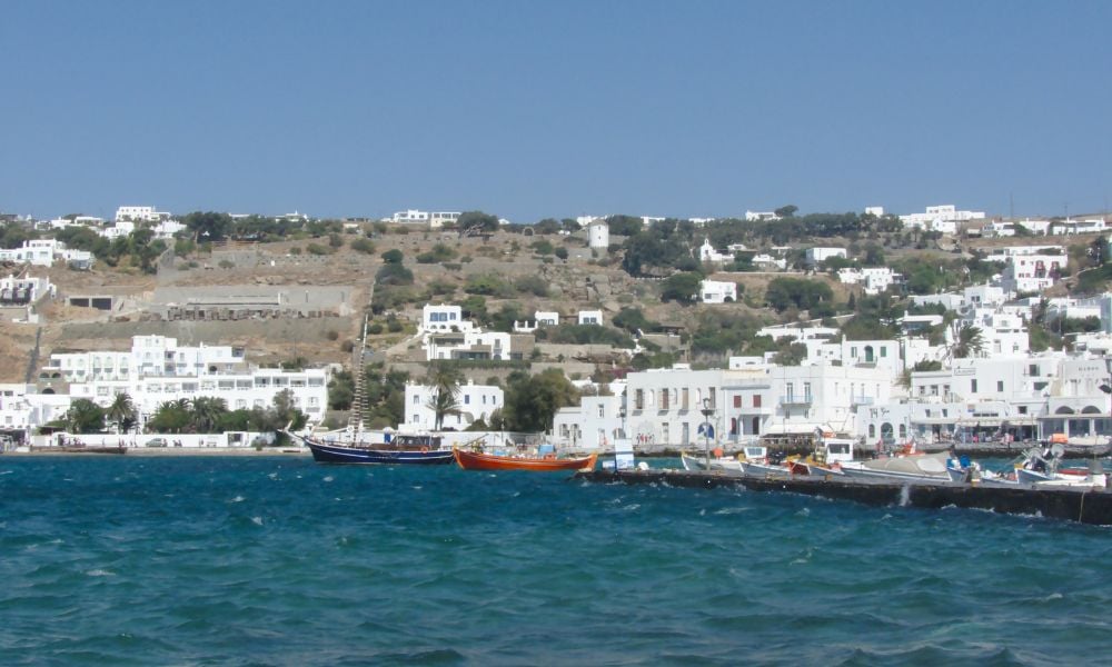 the old port of mykonos with boats and white buildings