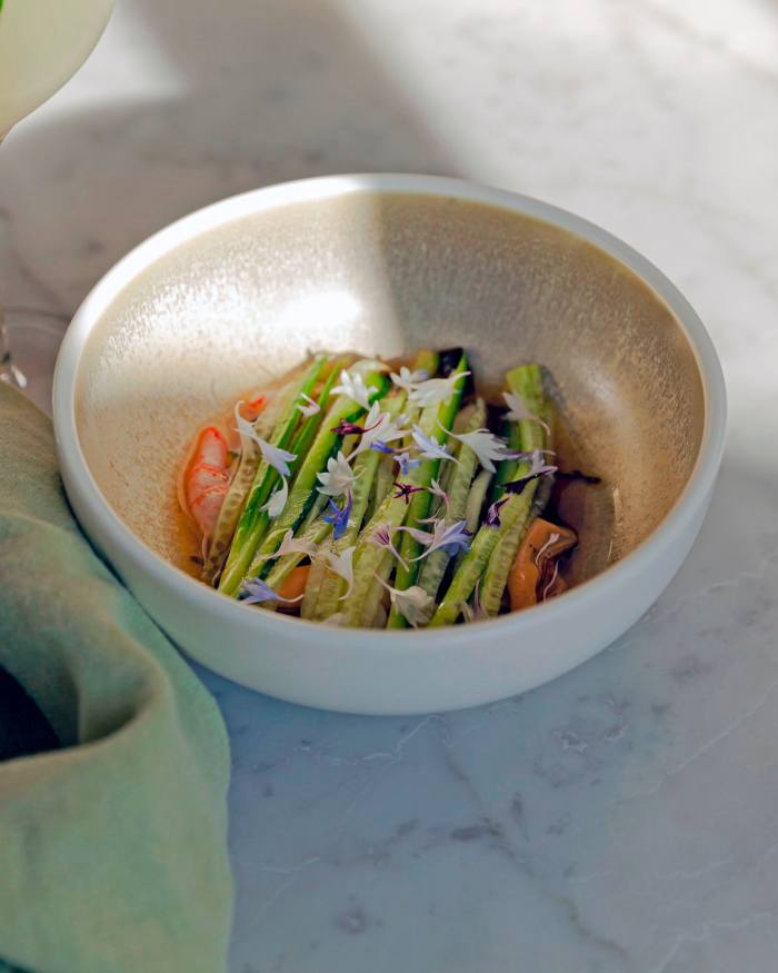 A bowl of mussels, cucumber, and honeydew in a green tomato water at Grey Gardens