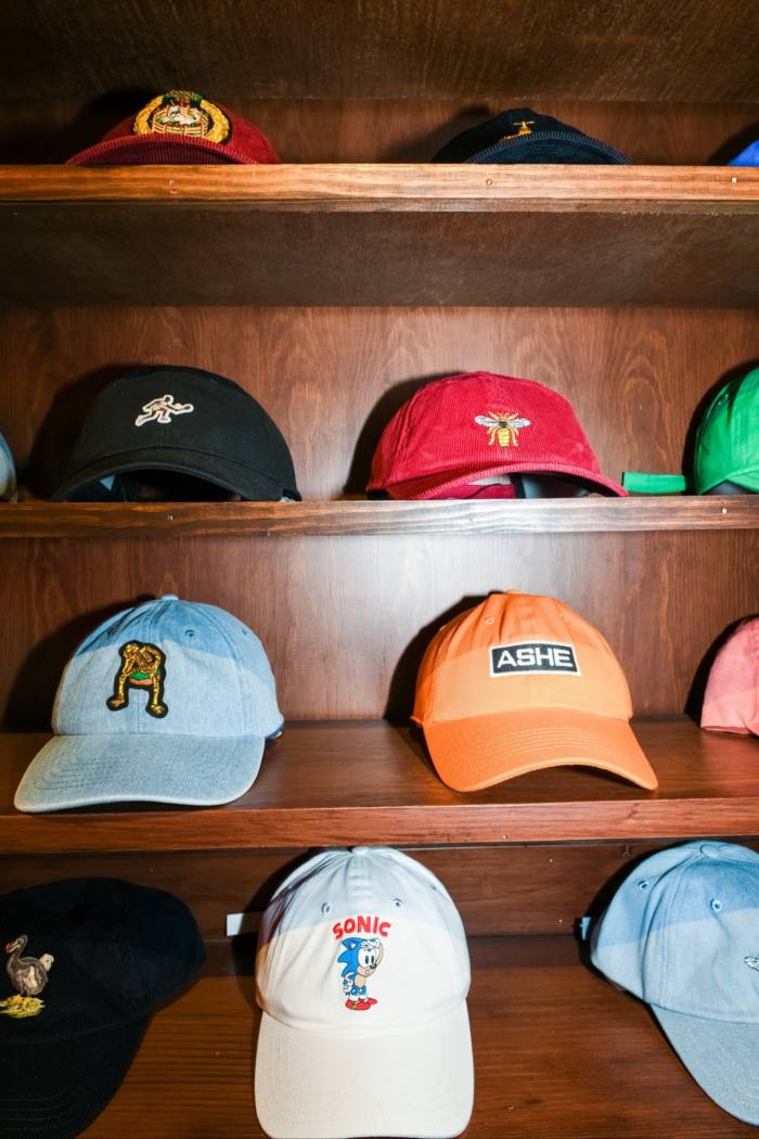 baseball caps on a shelf