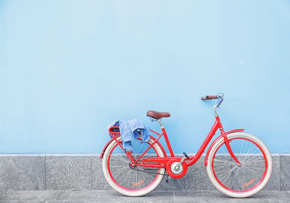 red bicycle against a blue backdrop