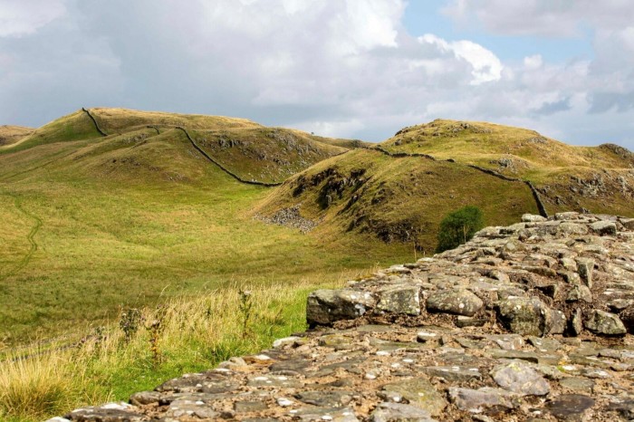 The remains of a wall run across fell land