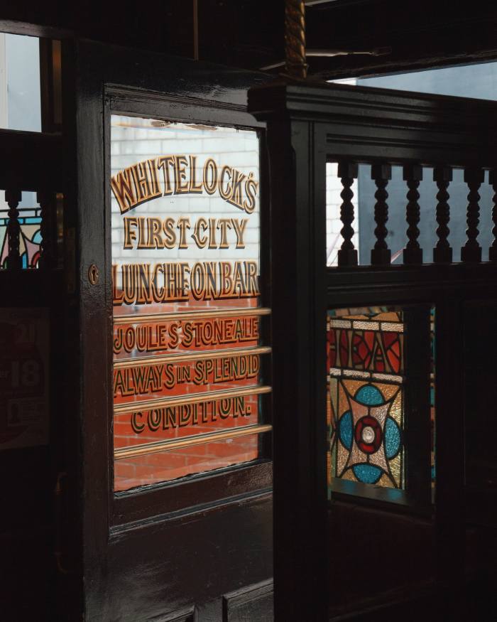 Stained glass and a mirror with lettering advertising Whitelocks bar