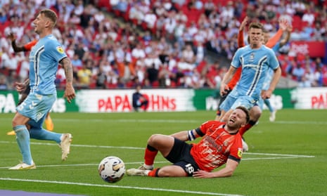 Luton Town’s Jordan Clark goes to ground after a challenge by Coventry City goalkeeper Ben Wilson, resulting in a yellow card for simulation during the Sky Bet Championship play-off final at Wembley Stadium.