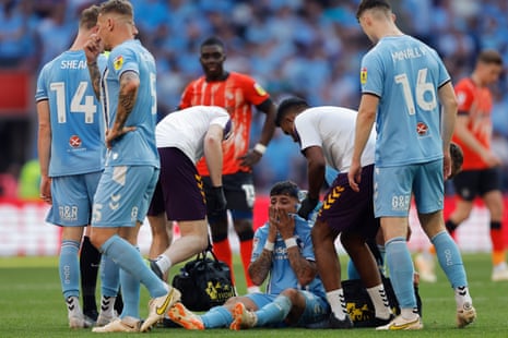 Coventry City's Gustavo Hamer receives treatment after going down injured against Luton Town.