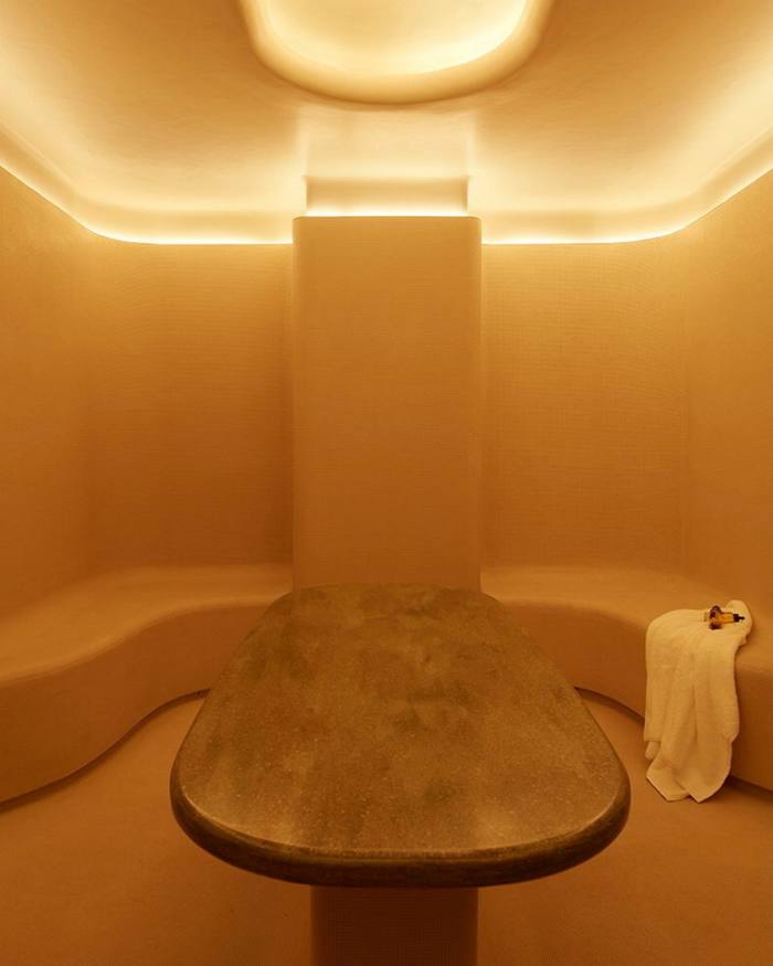 The gold-coloured sauna in the hotel’s spa, with a bronze marble counter in the middle