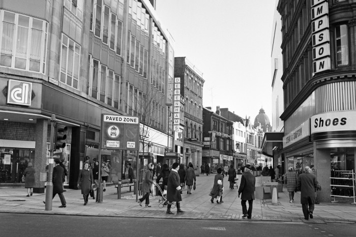 A black-and-white photo dated 1973 of a pedestrianised shopping street