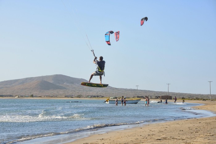 A man kitesurfing at the beach