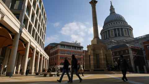 City workers in Paternoster Square, where the headquarters of the London Stock Exchange is based, in the City of London