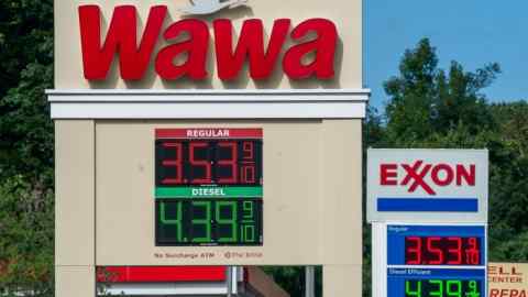 Petrol prices are displayed at gas stations on a highway in Maryland