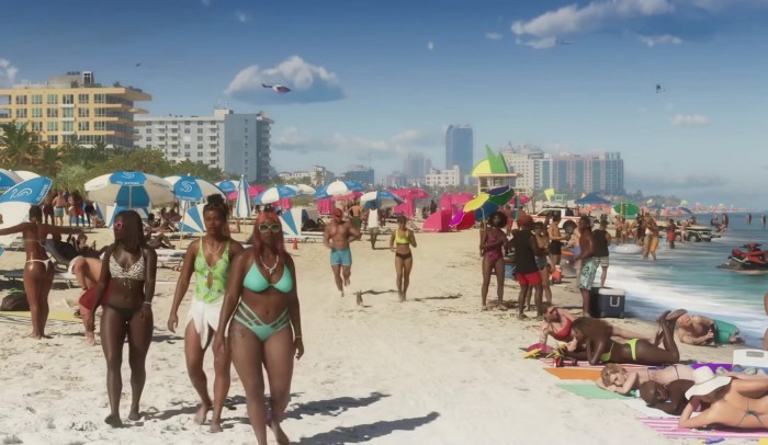 Sunbathers and people in bikinis stroll along a sandy beach