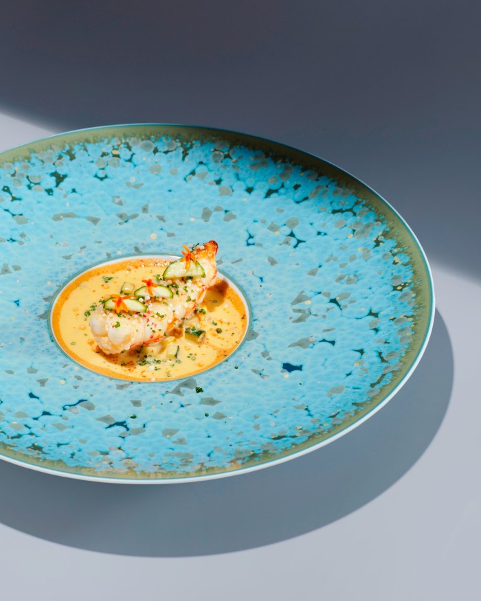 A delicate prawn dish on a turquoise plate at The Japanese by The Chedi
