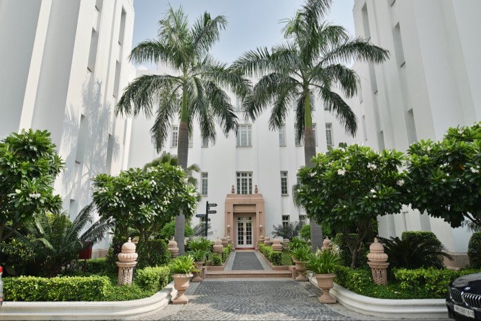 The Imperial hotel’s whitewashed, Art Deco-style buildings, with palm trees and bushes in the courtyard