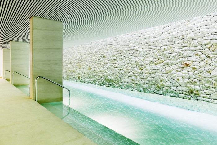 The spa pool in Square Nine, with a rough white-stone wall