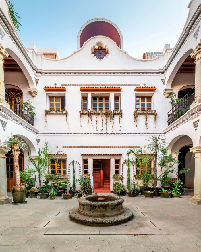 The courtyard of Grana B&B, surrounded by a stately white and red 18th-century building