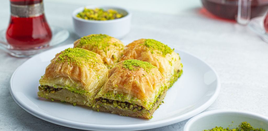 Baklava with Ground Pistachios on a white plate. 
