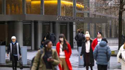 Pedestrians walking past Goldman Sachs’s headquarters in New York