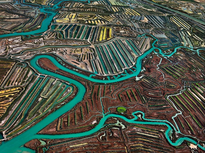 ‘Salinas #2, Cádiz, Spain’, 2013 by Ed Burtynsky: an aerial photograph of green waterways winding across earth-coloured plains