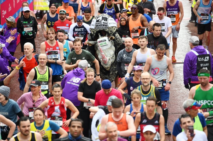 Runners in the 2023 London Marathon, with one participant wearing a rhinoceros costume
