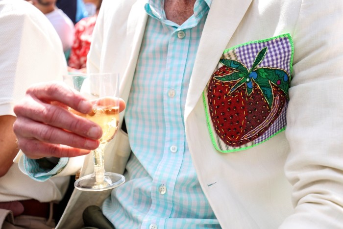 A detailed view of an embroidered strawberry that decorates the blazer of a spectator during day ten of The Championships Wimbledon 2023 at All England Lawn Tennis and Croquet Club on July 12, 2023