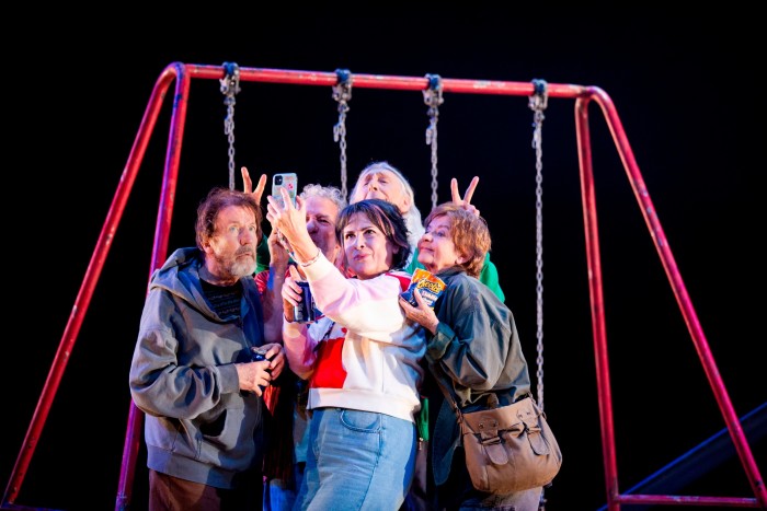 Five male and female members of the cast of ‘Seventeen’: middle-aged adults dressed as teenagers and larking around by a swing