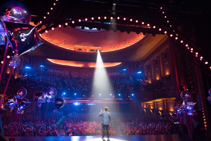 Local comedian Nick Robertson seen on stage from behind at the 2022 Melbourne International Comedy Festival