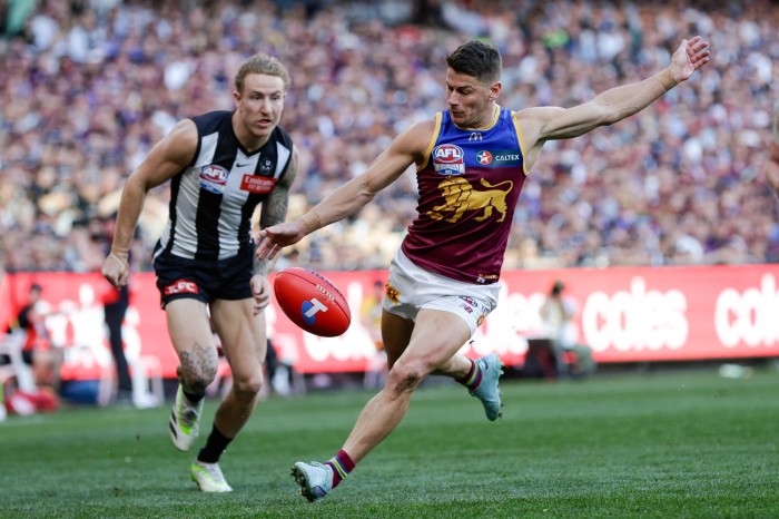 Two players from Brisbane Lions and Collingwood racing towards a ball at last year’s AFL Grand Final